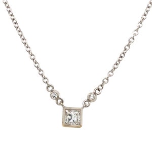 This beautiful pendant features a princess cut colorless gemstone bezel set in 18k white gold, with a cable chain.