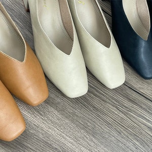 May include: Four pairs of women's shoes in different colours: brown, beige, light beige, and black. The shoes have a pointed toe and a low heel.