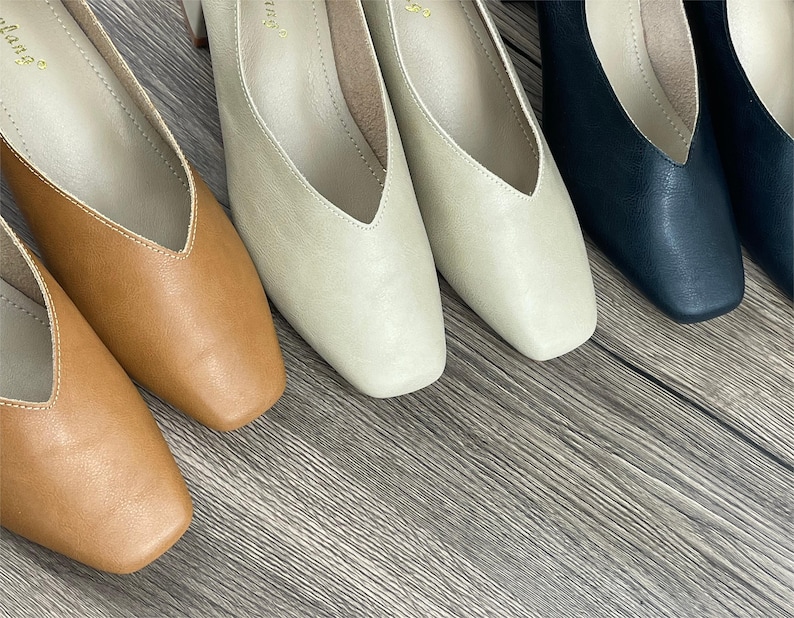 May include: Four pairs of women's shoes in different colours: brown, beige, light beige, and black. The shoes have a pointed toe and a low heel.
