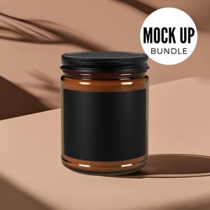 May include: A brown glass candle jar with a black lid and a black label. The jar is sitting on a light brown surface.