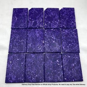 May include: Twelve rectangular tiles arranged in a grid, each featuring a deep purple base color with a distinct white marbled or veined pattern across the surface. The tiles have a smooth, flat finish and uniform shape, displaying a consistent aesthetic.