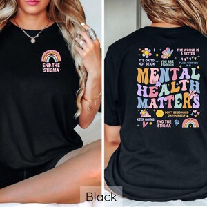 May include: Black t-shirt with a rainbow and the text "End the Stigma" on the front and a colorful graphic with the text "Mental Health Matters" on the back.