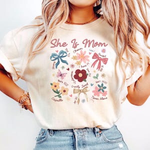 She Is Mom Shirt, Coquette Mother&#39;s Day Shirts, Religious Bow T-Shirts, Floral Mama Gift, Bible Verse Mom T-Shirt, Boho Floral Mama Crewneck