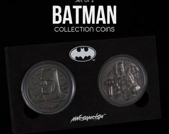 May include: A set of two officially licensed Batman collection coins. The coins are black and feature a Batman logo and a close-up of Batman's face.