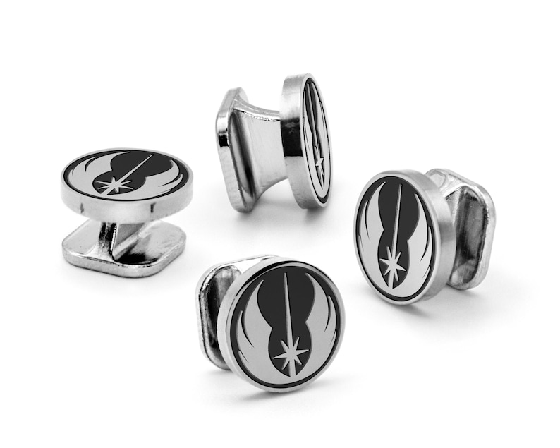 May include: Four silver cufflinks featuring a black and white Rebel Alliance symbol from Star Wars.