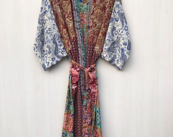 May include: A long, colourful silk robe with a paisley pattern. The robe has a tie belt and long sleeves.