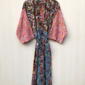 May include: A long, colorful silk robe with a paisley pattern. The robe has a tie belt and is made of a soft, flowing fabric.