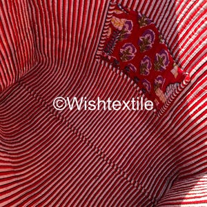 May include: The interior of a quilted fabric bag featuring a red and white vertical striped pattern. An internal pocket is attached to the side, showcasing a red fabric with a floral print in purple and yellow. The text Wishtextile is visible.