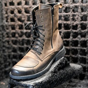 May include: A brown leather ankle boot with black laces and a zipper on the side. The boot has a thick black sole and is sitting on a black surface.