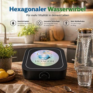 May include: A black water revitalizer with the text "Hexagonaler Wasserwirbel" and "Für mehr Vitalität in deinem Leben". The device has a circular design with a water droplet graphic. A glass pitcher and glass of water are next to the device.
