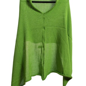 May include: A lime green knitted shawl with a V-neck and a long, asymmetrical hem.
