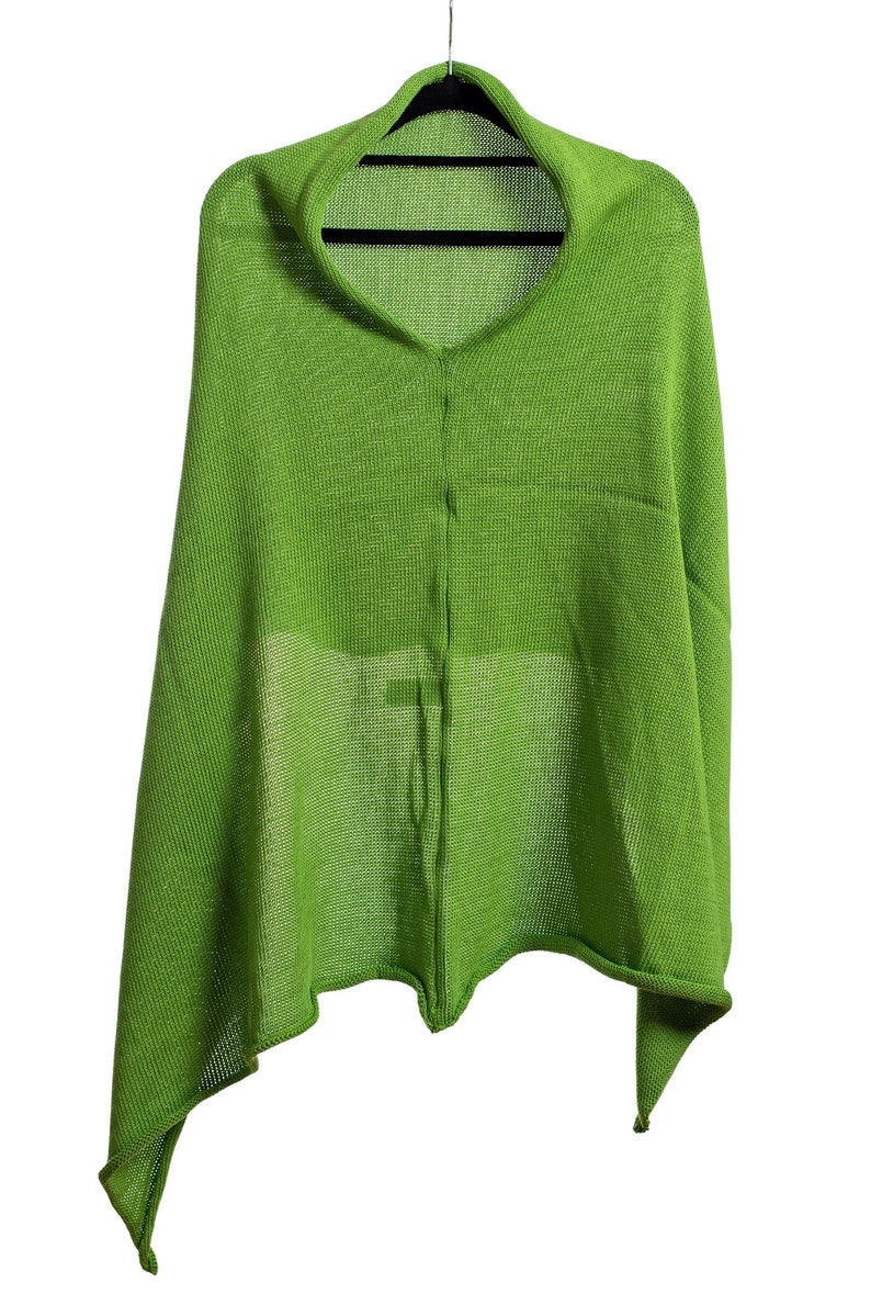 May include: A lime green knitted shawl with a V-neck and a long, asymmetrical hem.