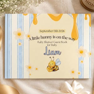 May include: A rectangular baby shower guest book with a light yellow and blue striped cover. The text reads September 13th 2026, A little hunny is on the way, Baby Shower Guest Book for Baby Liam. It features a cartoon bee and honey drips.