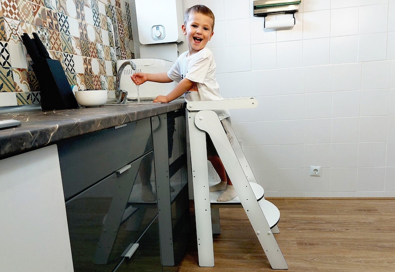 Child using learning tower