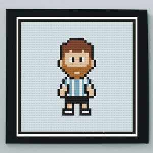 May include: A pixel art illustration of a person wearing a light blue and white striped shirt, black shorts, and brown hair. The person has a brown beard and is smiling.