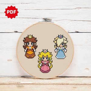 May include: Cross stitch pattern featuring three princesses from the Super Mario franchise: Peach, Daisy, and Rosalina. Each princess is depicted in their signature colors and attire.