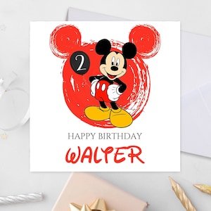 May include: A white card featuring a red and white illustration of Mickey Mouse. Mickey Mouse is holding a black balloon with the number 2 on it. The text "Happy Birthday WALTER" is printed below the illustration.