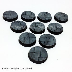 May include: Ten unpainted, circular miniature bases with a stone-effect surface. Each base has a dark grey colour and a black rim. The bases are arranged in a fan shape. The text "Product Supplied Unpainted" is visible. Ideal for tabletop gaming.