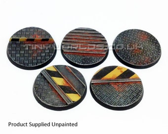 May include: Five unpainted, circular miniature bases with a diamond plate texture. Each base features a unique design with yellow and black hazard stripes, red accents, and metal bars. The bases are designed for miniature gaming.