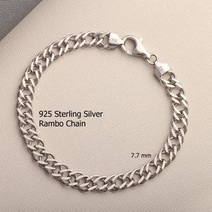 May include: A 925 sterling silver Rambo chain bracelet with a lobster claw clasp. The metal links are polished and reflective. The text 925 Sterling Silver Rambo Chain and 7.7 mm are visible on the image. The clasp is stamped with Italy.