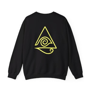 May include: Black sweatshirt with a yellow graphic of a triangle with a wave inside. The wave is stylized to look like an eye.