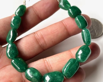 May include: A bracelet featuring polished, oval-shaped, deep green beads. The beads are strung together with a silver-colored chain and clasp. The bracelet is shown against a light background.