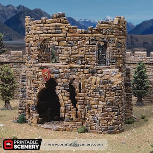 May include: A detailed model of a stone castle tower with a partially ruined top. The tower is constructed from various sized brown and tan stones. A red shield with a gold emblem hangs above an arched entrance. The background features mountains and trees.