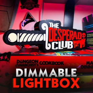 May include: A black, white, and red 3D-printed sign featuring the text THE DESPERADO CLUB in a stylized font. The design includes a white sword-like graphic on the left and a red skull icon on the right with a dripping paint effect.
