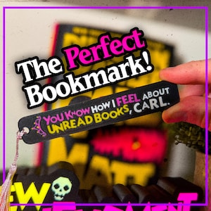 May include: A black bookmark with the text "YOU KNOW HOW I FEEL ABOUT UNREAD BOOKS, CARL." and "The Perfect Bookmark!" in white and pink. The bookmark has a pink tassel and a decorative design.