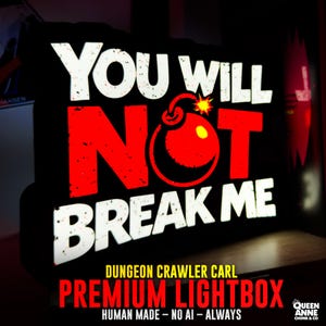 May include: A rectangular black lightbox featuring the white text YOU WILL, a large red bomb graphic, and the white text NOT BREAK ME. The design has a distressed texture, and the lightbox emits a bright glow from the letters and the bomb icon.