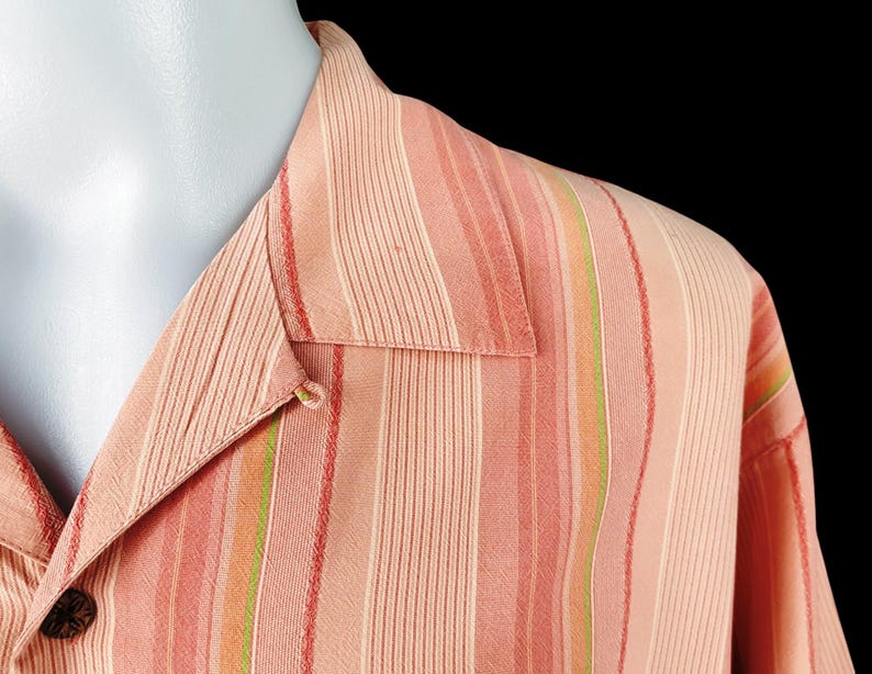 May include: A pink and green striped button-down shirt with a collar.