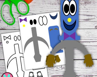 May include: A blue, cartoon-like character with a smiling face, bow tie, and brown gloves. The character is made of paper and is next to printed paper cutouts and craft supplies, including scissors and glue.