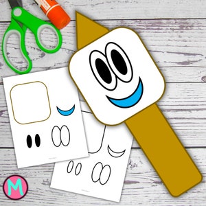 May include: A craft project featuring a smiling marshmallow character on a stick. The character has black eyes and a blue smile. Additional printed paper elements and craft supplies, including green scissors and glue, are visible.