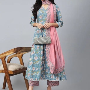 May include: A blue and pink floral print kurta with matching pants and a pink dupatta. The kurta has a V-neck and three-quarter sleeves. The pants are ankle-length and the dupatta is sheer with a beaded border.