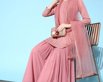 May include: A pink, pleated palazzo pant set with a matching dupatta. The set features gold embroidery and a delicate, sheer fabric. The model is wearing the set with gold sandals.