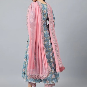May include: A blue and pink floral print dress with a matching pair of pants and a pink sheer dupatta. The dress has a long, flowing skirt and a fitted bodice. The dupatta is draped over the shoulders and has a delicate floral border.