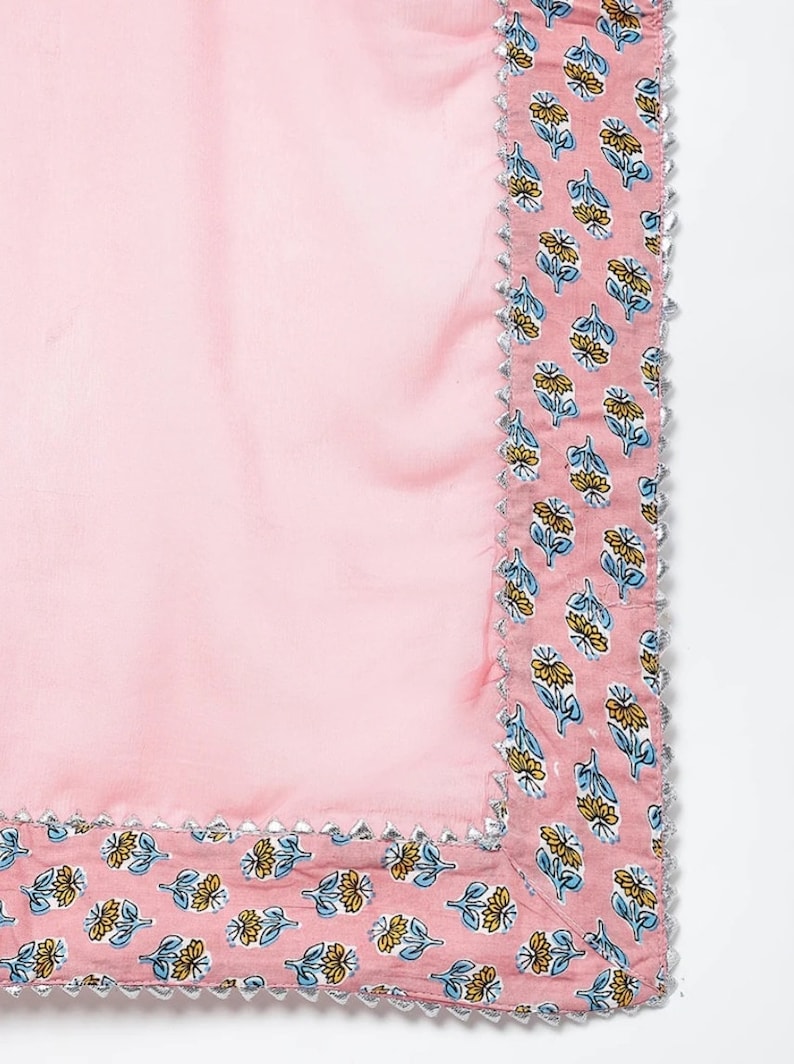 May include: Pink fabric with a floral print border. The border has a silver trim.