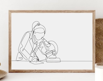 May include: A framed line art print depicts a person using a microscope. The artwork is a continuous line drawing in black against a white background. The frame is made of light brown wood. The print is displayed on a white surface.