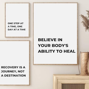 May include: Three framed motivational quotes on a white wall. The quotes are: "One step at a time, one day at a time", "Recovery is a journey, not a destination", and "Believe in your body's ability to heal".