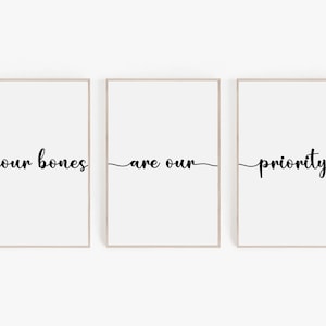 May include: Three framed prints with the text "your bones are our priority" in black cursive font on a white background.
