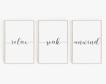 Puede incluir: Tres impresiones enmarcadas con las palabras "relax", "soak" y "unwind" escritas en cursiva.