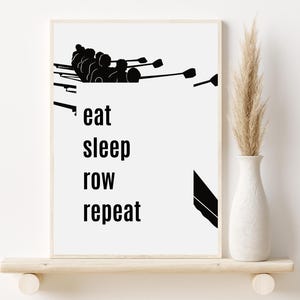May include: Black and white illustration of a rowing team with the text "eat sleep row repeat" below.