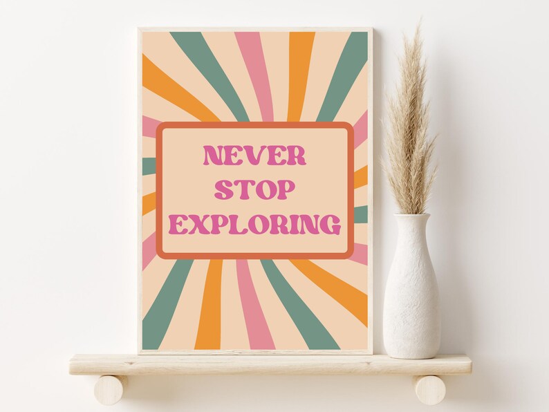 May include: A retro-style poster with a peach background and a radiating pattern of orange, pink, and teal stripes. The poster features a pink rectangle with the text "NEVER STOP EXPLORING" in white.