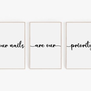 May include: Three framed prints with the text "your nails are our priority" in black cursive font on a white background.
