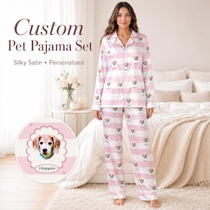 May include: A silky satin pajama set featuring a light pink and white horizontal striped pattern with a repeating graphic of a dog's face inside a scalloped frame. The text on the image reads Custom Pet Pajama Set, Silky Satin, Personalized, and Hopper.