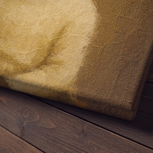 May include: Close-up of a canvas print with a vintage aesthetic. The canvas has a textured surface with visible cracks, and the color palette is dominated by warm, earthy tones. The canvas is placed on a dark wooden surface.