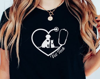 May include: Black t-shirt with a white graphic of a dog and cat inside a heart with a stethoscope. The text "Vet Tech" is below the heart.
