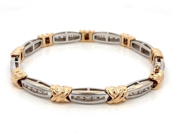 May include: A gold and silver bracelet with a diamond-encrusted band and a delicate, interwoven design.
