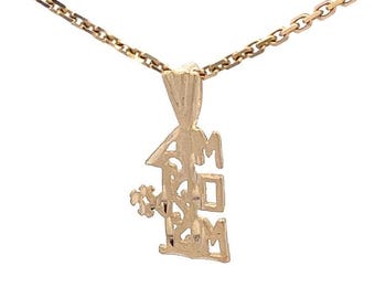 May include: A gold-colored pendant necklace with a chain. The pendant is in the shape of a house with the word "MOM" cut out. A small flower is on the left side of the house.