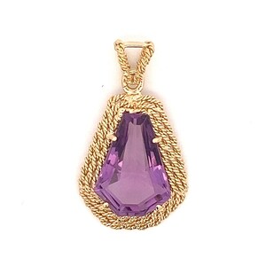 May include: A gold pendant featuring a large, faceted amethyst gemstone set in a rope-like design.